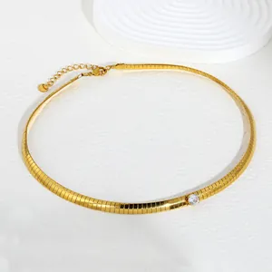Close-up of gold stainless steel blade chain necklace with a sparkling white zircon stone