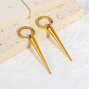 Macro detail of 18K gold plated stainless steel spike hoop earrings on stone