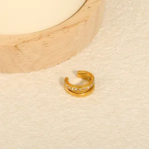 Detail view of a gold-plated stainless steel C-shaped ear cuff with sparkling rhinestones