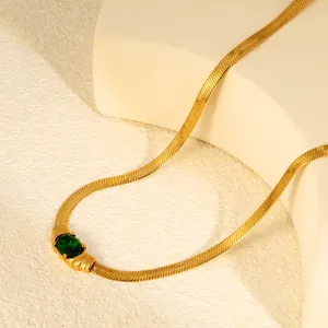 Detailed shot of vintage gold blade chain necklace with oval green zirconia stone