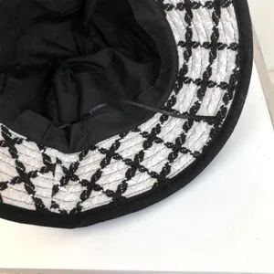 Close-up detail showing the interior lining and knit texture of a retro checkered bucket hat