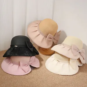 French Hepburn style straw sun hat with elegant organza bow and wide brim