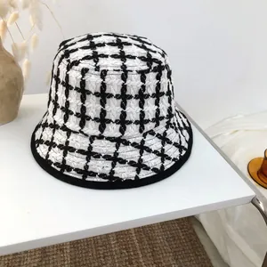 Close-up of black and white plaid knit bucket hat with soft texture for winter