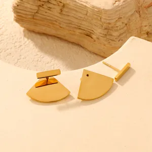 Macro detail showing the detachable parts of these gold fan-shaped stud earrings.