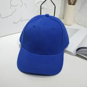 Detailed view of a vibrant blue unisex solid color baseball cap in a minimalist setting
