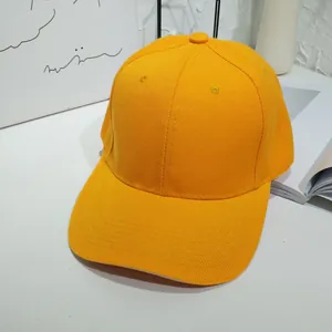 Close-up of a vibrant yellow plain baseball cap with visible twill fabric texture