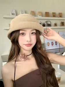 Close-up of a French style knitted cloche hat with a rolled brim worn by an Asian model