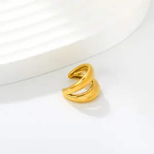 Detailed close-up of a minimalist golden C-shaped stainless steel ear cuff on white.