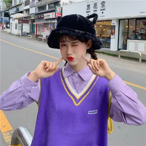 Cute black plush bucket hat with cat ears for women worn by model on an urban street