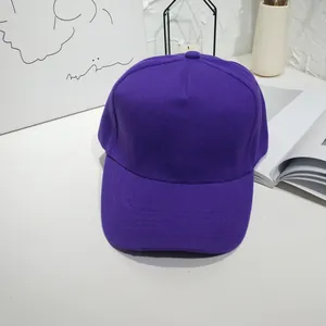 Close-up of a vibrant purple solid color baseball cap with a curved brim.