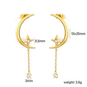 Detail view of gold-plated star and moon earrings with cubic zirconia pendants