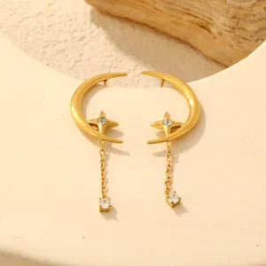 Detailed macro view of gold plated crescent moon and star earrings with zirconia tassels