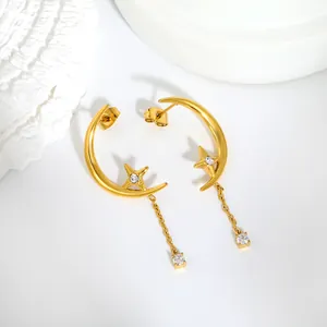 Detailed shot of gold-plated stainless steel star and moon tassel earrings with zircons