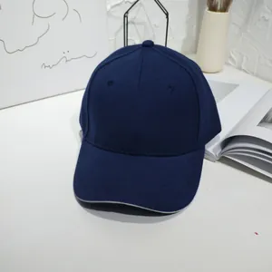 Detailed close-up view of a classic navy blue plain cotton baseball cap with curved brim