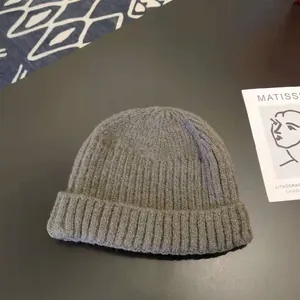 Macro detail of high-quality gray winter knitted beanie with classic ribbed pattern