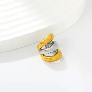 Detailed macro view of a fashionable three-layer spiral C-shaped ear cuff in gold and silver