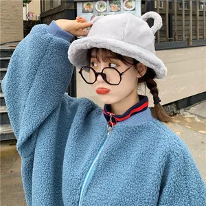 Model wearing a cute grey plush bucket hat with bear ears and blue teddy jacket