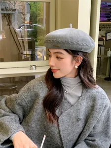 Detail view of a grey knitted beret for women, showing stylish texture and comfortable fit.