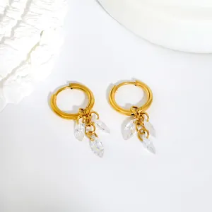 Detail view of gold stainless steel hoop earrings with marquise zirconia drops
