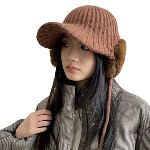 Warm winter knitted baseball cap with plush faux fur earflaps for women in tan color