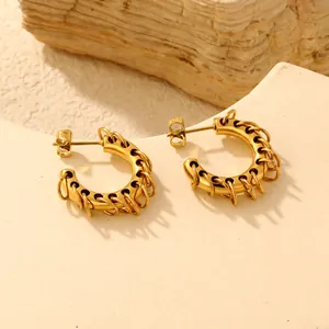 Detailed view of 18K gold-plated C-shaped hoop earrings with unique small ring accents