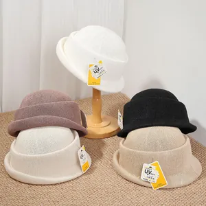 Elegant Hepburn style rolled-edge hats in various neutral colors with UV protection tags