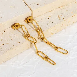 Close-up of gold-plated chain link earrings with a unique hammered metal texture.