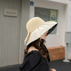 Side view of elegant wide-brim sun hat with black glue UV lining and bow detail
