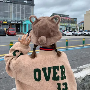 Detailed back view of a cute brown plush bucket hat with bear ears for winter warmth