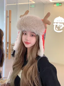 Macro view of a cute plush reindeer antler trapper hat worn by a model in a cozy cafe