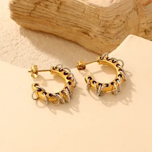 Close-up of 18K gold plated C-shaped hoop earrings with creative silver coil details