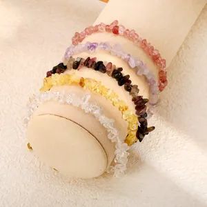 Gros plan de cinq bracelets colorés en éclats de cristal naturel sur un support.