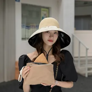 Elegant wide brim straw sun hat with black vinyl lining and a matching storage pouch