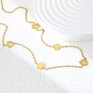Detail view of golden stainless steel maple leaf necklace with delicate chain texture.