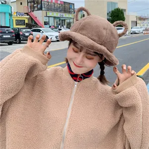 Close-up of a cute brown fuzzy bucket hat with teddy bear ears for cozy winter fashion