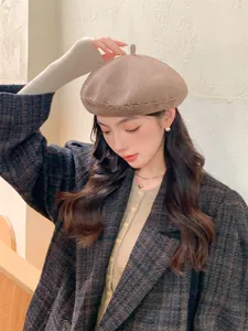 Asian model wearing a stylish brown knitted beret hat with breathable mesh texture