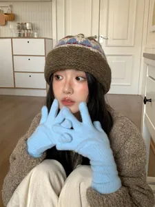 Asian model wearing retro folk style knitted wool beanie hat with thick brown brim for winter