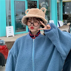 Sweet beige plush bucket hat with cute ears decoration shown on an Asian female model