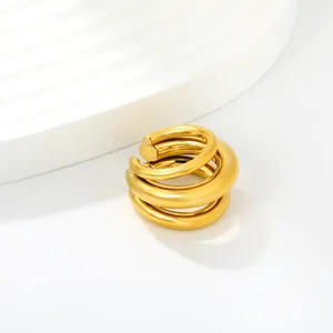 Detail view of a thick golden C-shaped spiral ear cuff with a polished metallic finish.
