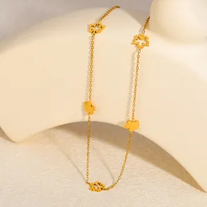Detailed close-up of a gold-plated stainless steel necklace with maple leaf charms.