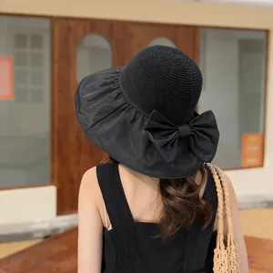 Detailed back view of a black wide-brim sun hat featuring a decorative large bow detail