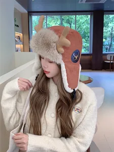 Close-up detail of plush winter trapper hat with cute reindeer antlers and protective ear flaps