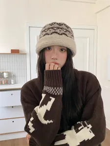 Asian model wearing a retro ethnic style knitted wool bucket hat in warm brown tones.
