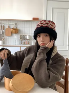 Young Asian model wearing a warm fair isle knit beanie in a cozy home kitchen