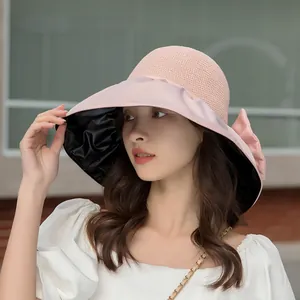 Stylish pink summer sun hat for women featuring vinyl lining and a bow for UV protection