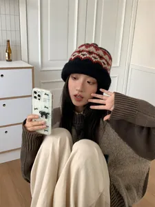 Detail of female model wearing an ethnic pattern wool knit bucket hat indoors