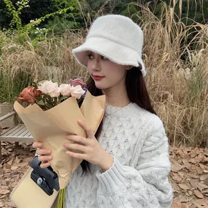 Fashionable white plush bucket hat for women in warm winter outdoor setting