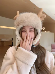 Detailed view of a cute beige faux-fur trapper hat with deer antlers on an Asian woman