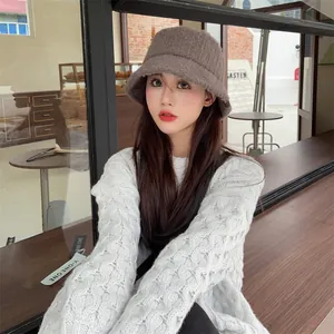Detailed view of a warm fuzzy Maillard style bucket hat worn by a model for winter.