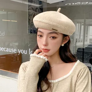 Elegant beige knitted beret hat for women featuring a breathable woven texture design